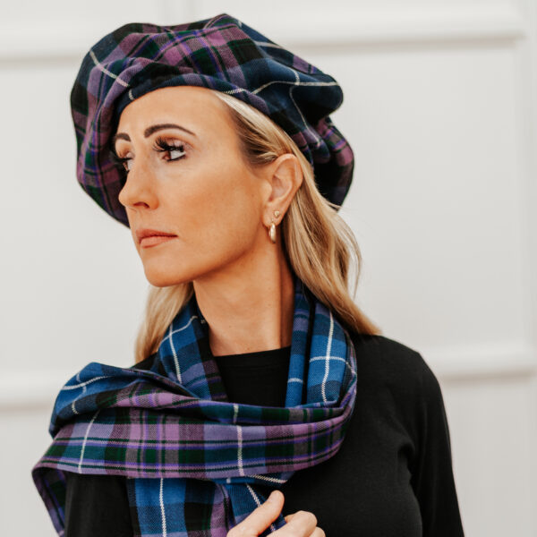 A woman wearing a plaid hat and scarf.