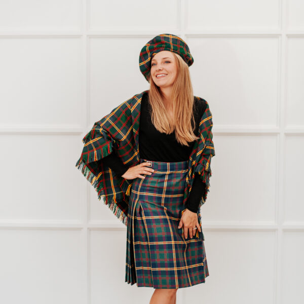 A woman in a plaid skirt poses for a photo.