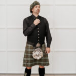 A man wearing a Quality Wool Blend Kilt with Matching Tartan Flashes and FREE Kilt Hanger.
