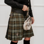 A man wearing a Quality Wool Blend Kilt with Matching Tartan Flashes and FREE Kilt Hanger.