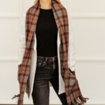 A woman wearing the Tartan Pocket Scarf - Homespun Wool Blend.