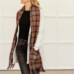 A woman wearing the Tartan Pocket Scarf - Homespun Wool Blend.