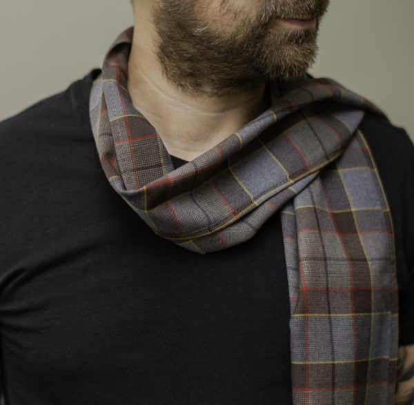 A man, resembling Jamie Fraser, wearing a Tartan Scarf - OUTLANDER Premium Wool - Jamie Fraser Special.