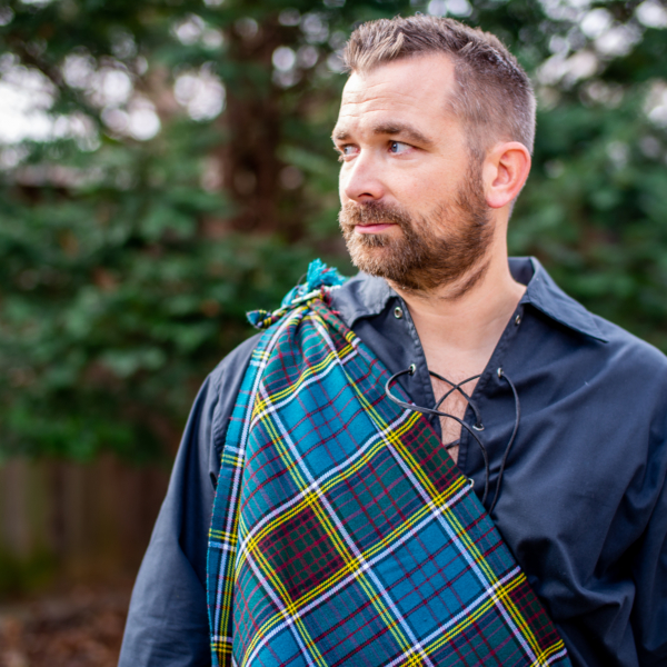 A man with a plaid scarf around his neck.