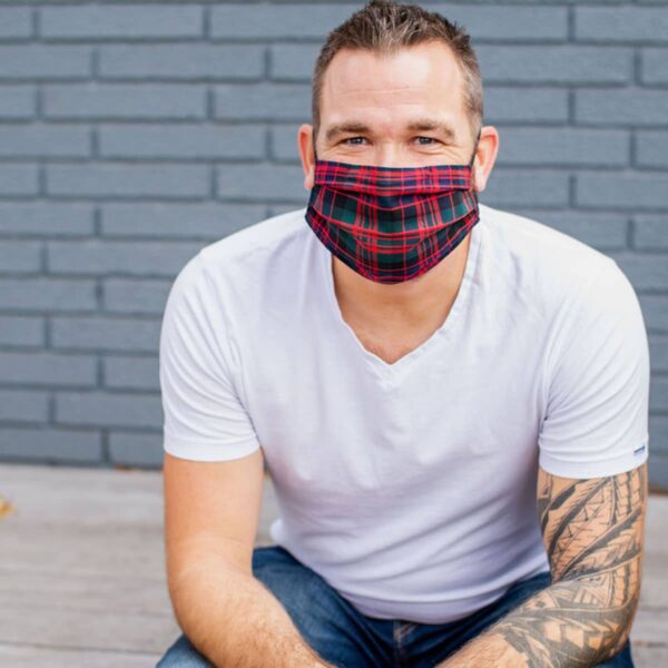 A man wearing a plaid face mask.