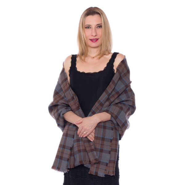 A woman is showcasing an exquisite OUTLANDER Stole Poly/Viscose Tartan adorned with a mesmerizing plaid pattern.