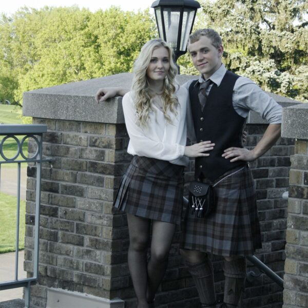 A man and a woman dressed in OUTLANDER Billie-Style Kilted Mini-Skirt Poly/Viscose made of poly/viscose fabric.