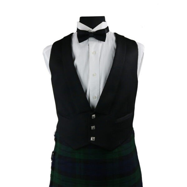 A black and green kilt with a bow tie, available for rental, displayed on a mannequin.