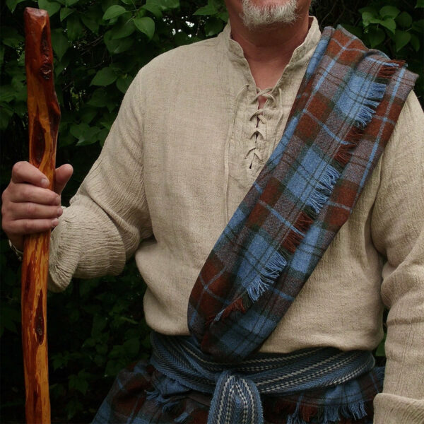 A man holding a Heavy Weight 16oz Premium Wool Ancient Kilt stick.