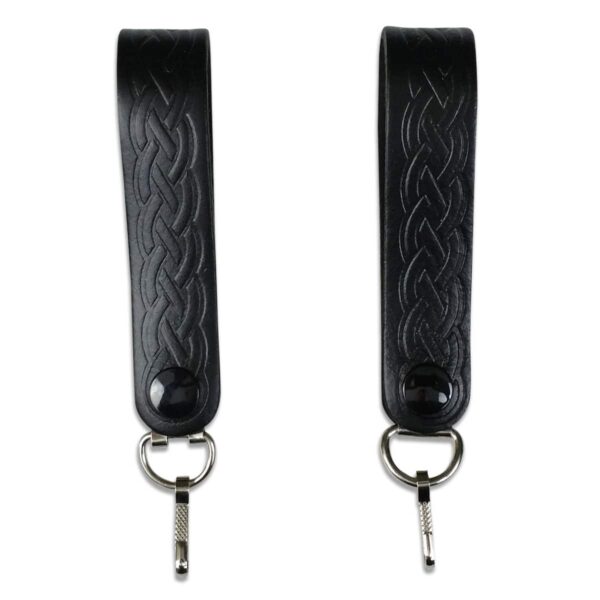 A pair of black leather straps with metal hooks.