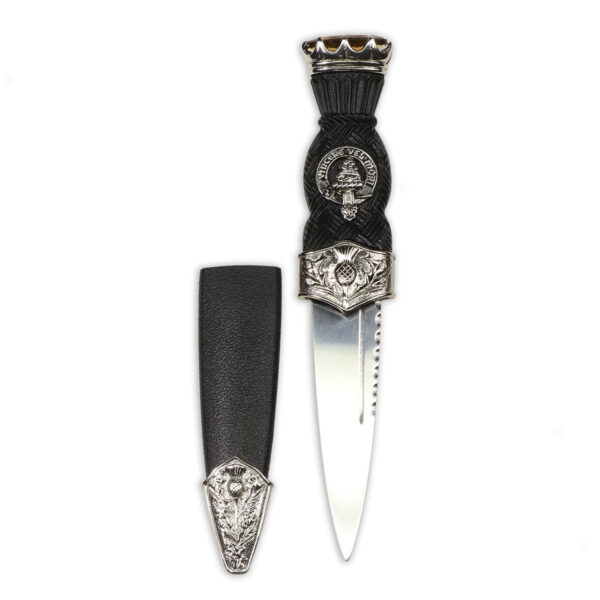 A MacNeil Thistle Mount Clan Crest Sgian Dubh with a silver handle and a black handle.