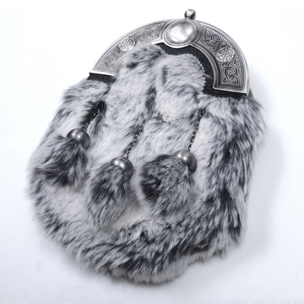 A black and white SEO fur bag with silver tassels.