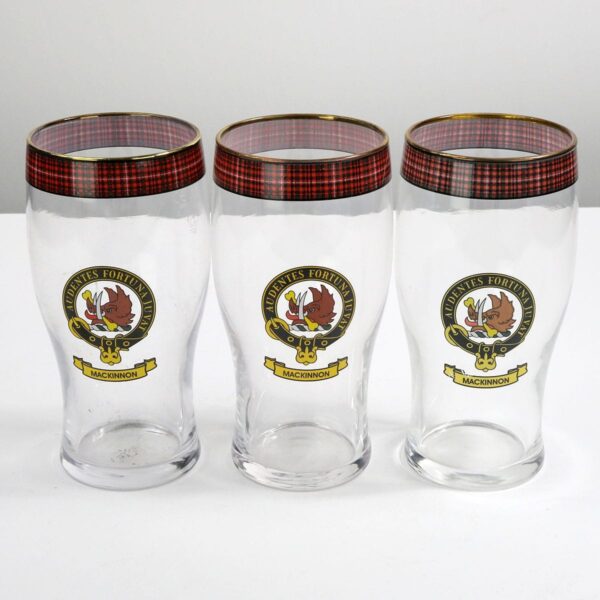 Three MacKinnon Clan Crest Tartan Pub glasses on a white surface.