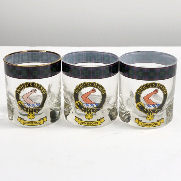 Three glass tumblers with the scottish crest on them.