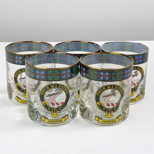 A set of six glasses with a crest on them.