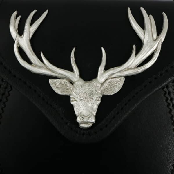 A black leather bag with a deer head on it.