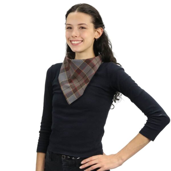 A young girl wearing a plaid Outlander Tartan Bandana Masks - Wool Free.