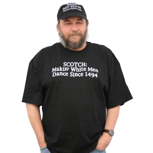 A man wearing a black t-shirt that says Black T-shirt Scotch: Makin' White Men Dance Since 1494.