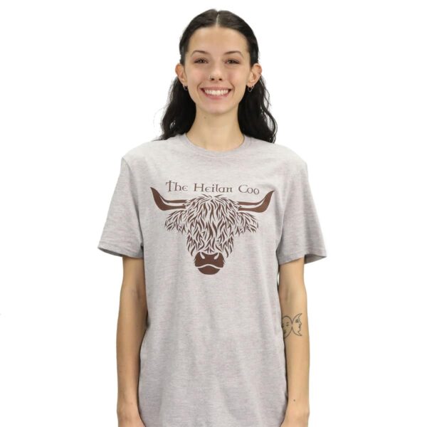 A woman wearing a grey Heilan Coo T-Shirt. She looked stylish and comfortable in her Heilan Coo T-Shirt.