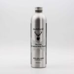 A bottle of Nutdust - Wildling body powder on a white background.