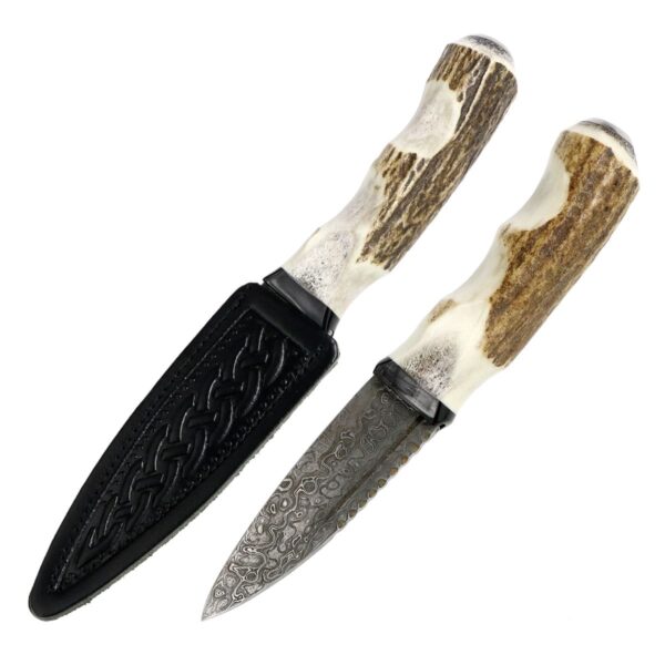 A pair of Stag Antler Damascus Steel Sgian Dubh knives with a black handle.