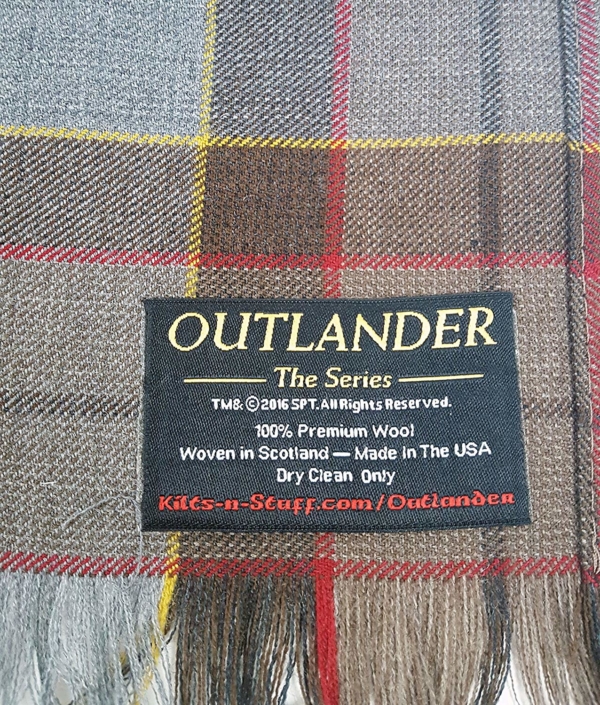 A Tartan Scarf - OUTLANDER Premium Wool - Jamie Fraser Special with a label on it.