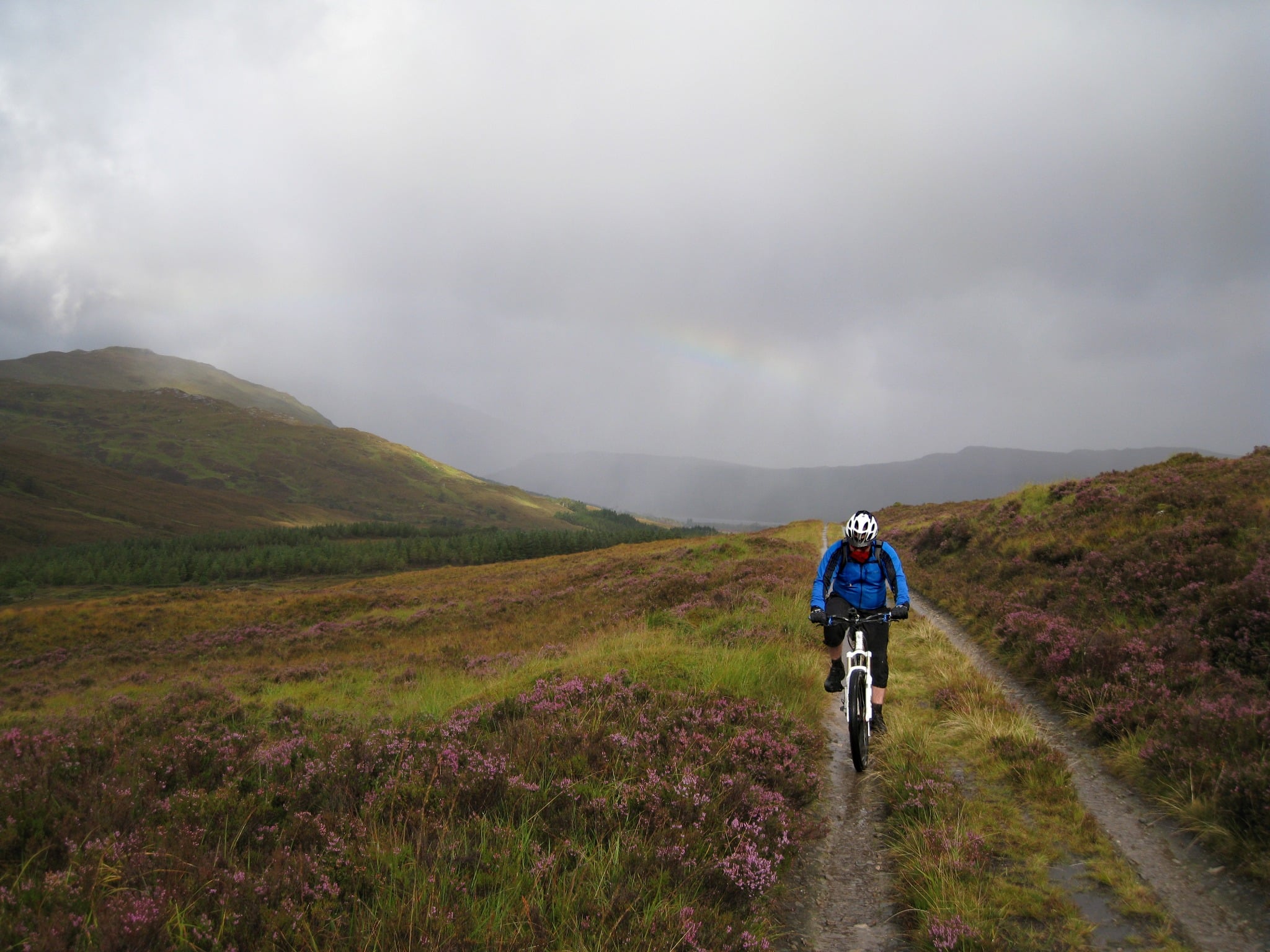 A cyclist riding in the rain in the Scottish Highlands