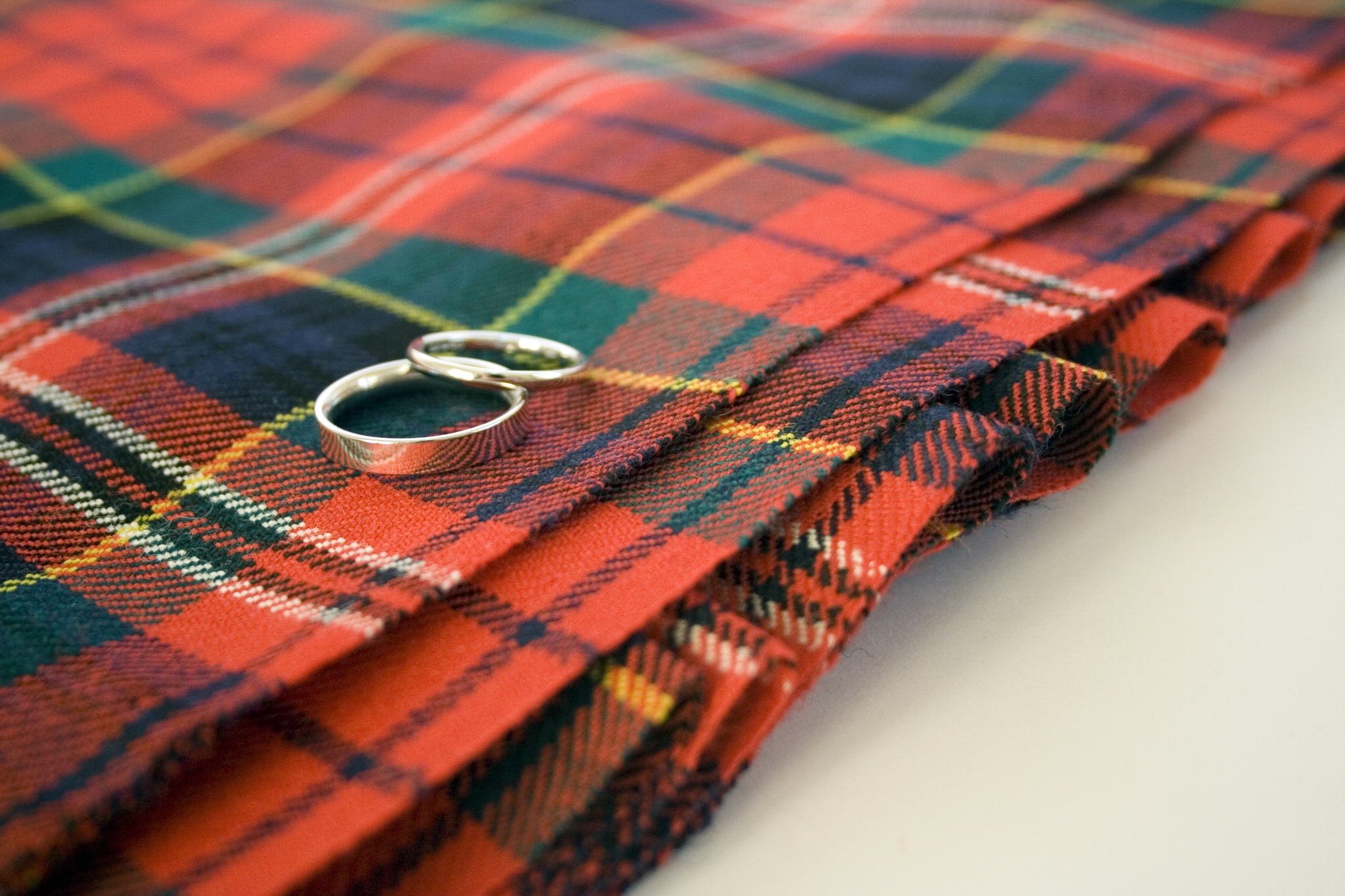 Wedding rings on a piece of red tartan